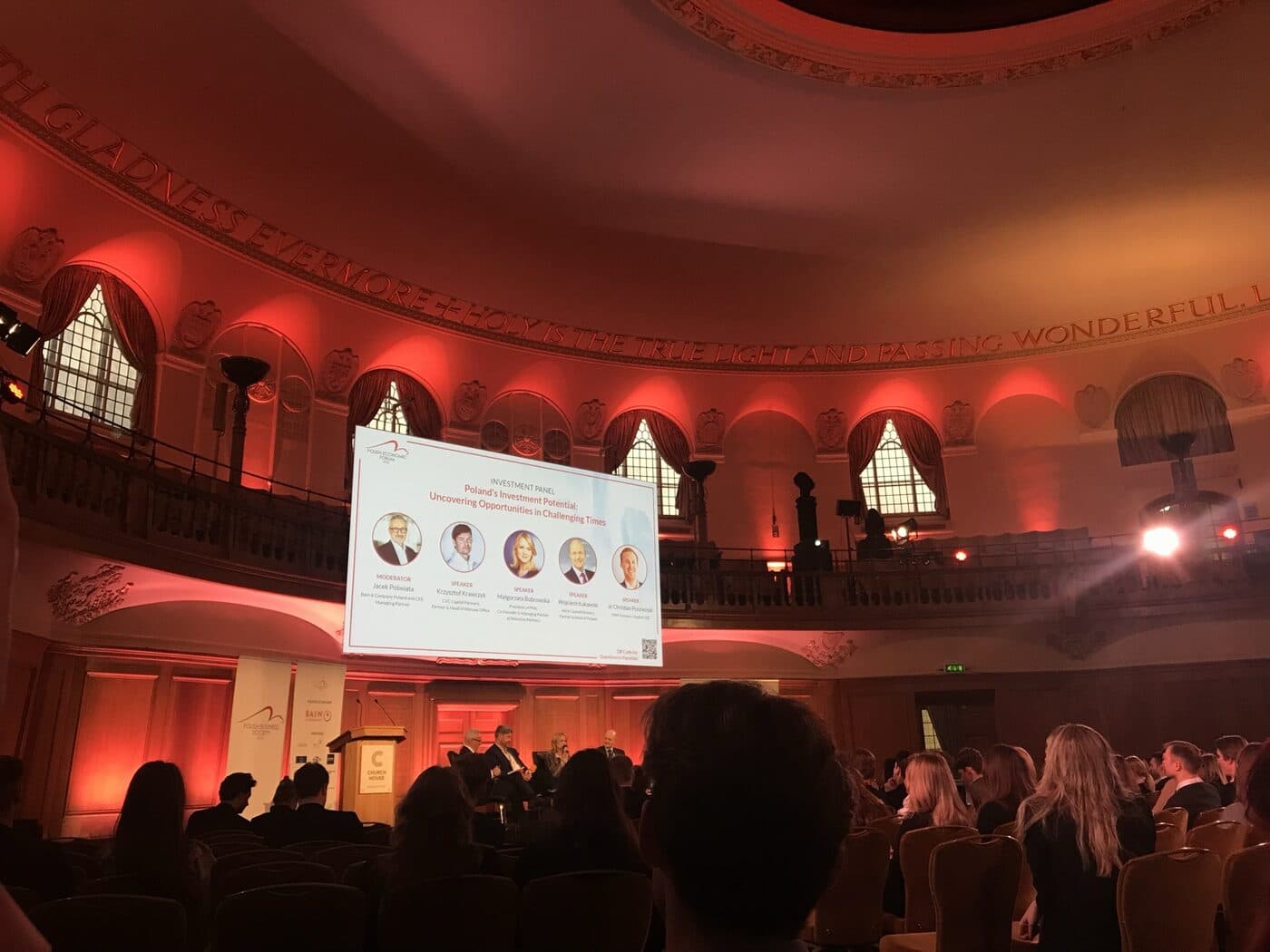 Conference room in London during a talk, with a presentation on screen